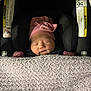 Ruby joined the competition — help win amazing prizes! baby, newborn, sleeping, pink_hat, blanket, car_seat, warning_label, infant, child, cute, peaceful, soft, cozy, indoors, portrait, headwear, clothing, person, resting, toddler