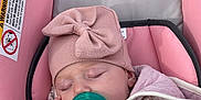Ruby is registered to the contest to win money with this photo: baby, blanket, bundle, car_seat, child, comfort, cozy, cute, hat, headwear, indoor, infant, pacifier, peaceful, pink, portrait, resting, sleeping, soft, wearing