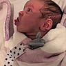 Eliyah'Ann is registered to the contest to win money with this photo: newborn, baby, infant, child, face, profile, eyes_open, tongue, pacifier, blanket, swaddled, wrapped, bed, bedding, soft, portrait, indoors, sleeping_area, pink, stars