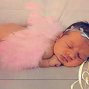 Eliyah'Ann is registered to the contest to win money with this photo: baby, sleeping, newborn, child, portrait, pink, tutu, headband, fluffy, pastel, indoor, close_up, peaceful, face, curled_up, blanket, soft_lighting, photography, love, infant
