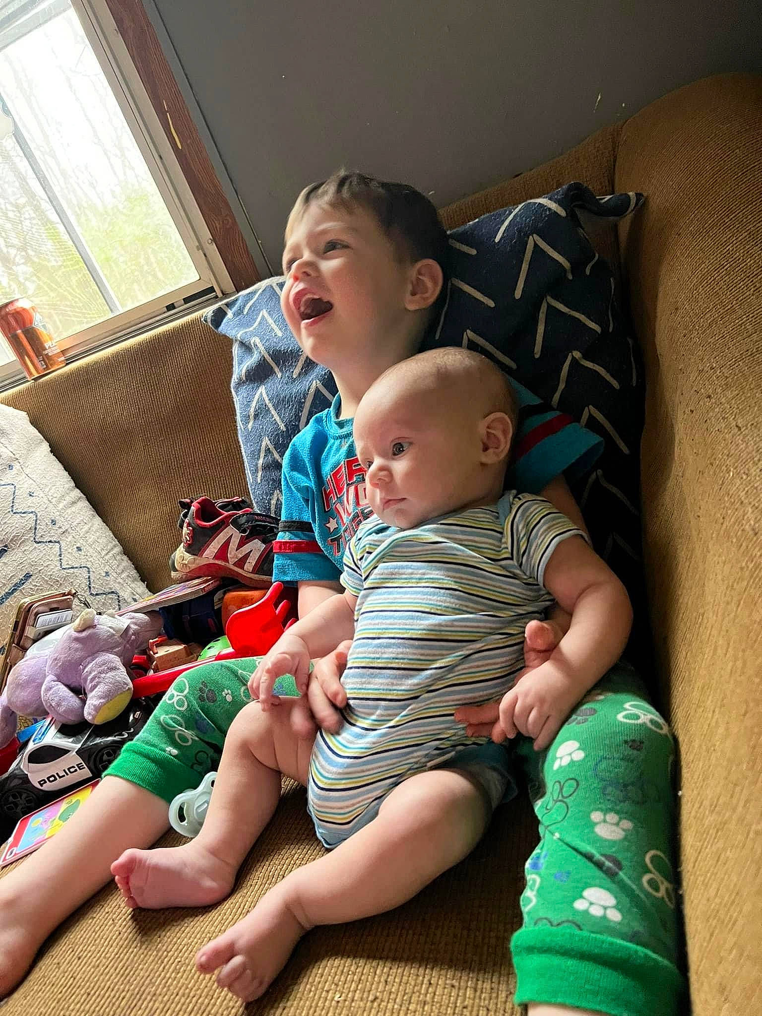 Isaac joined the competition — help win amazing prizes! baby, comfort, couch, facial_expression, finger, fun, hairstyle, happy, knee, lap, leg, living_room, person, shoulder, skin, smile, standing, thigh, toddler, window