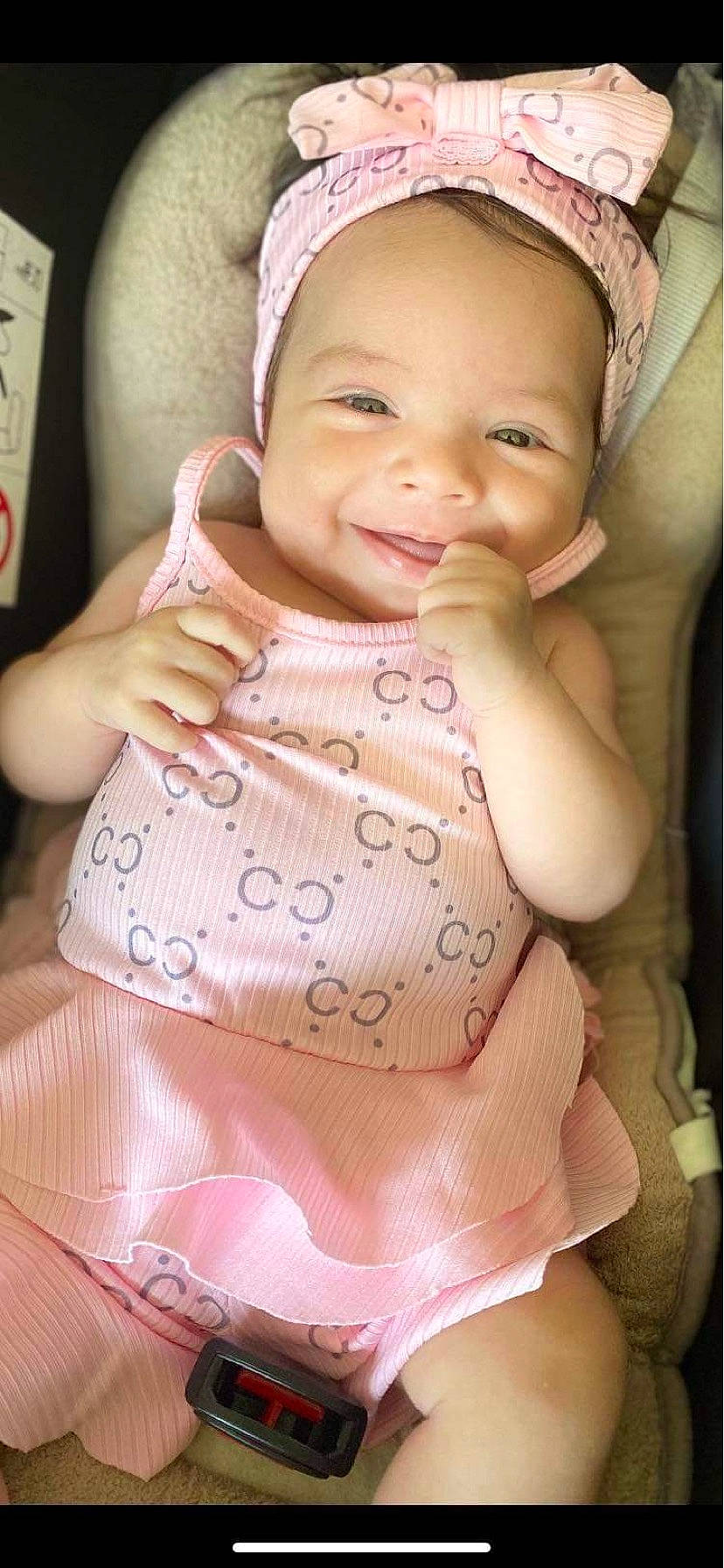 Kayla participe au concours pour gagner de l'argent avec cette photo : baby, baby_toddler_clothing, cheek, clothing, dress, facial_expression, gesture, happy, head, joy, lip, mouth, neck, organ, outerwear, person, pink, product, skin, sleeve