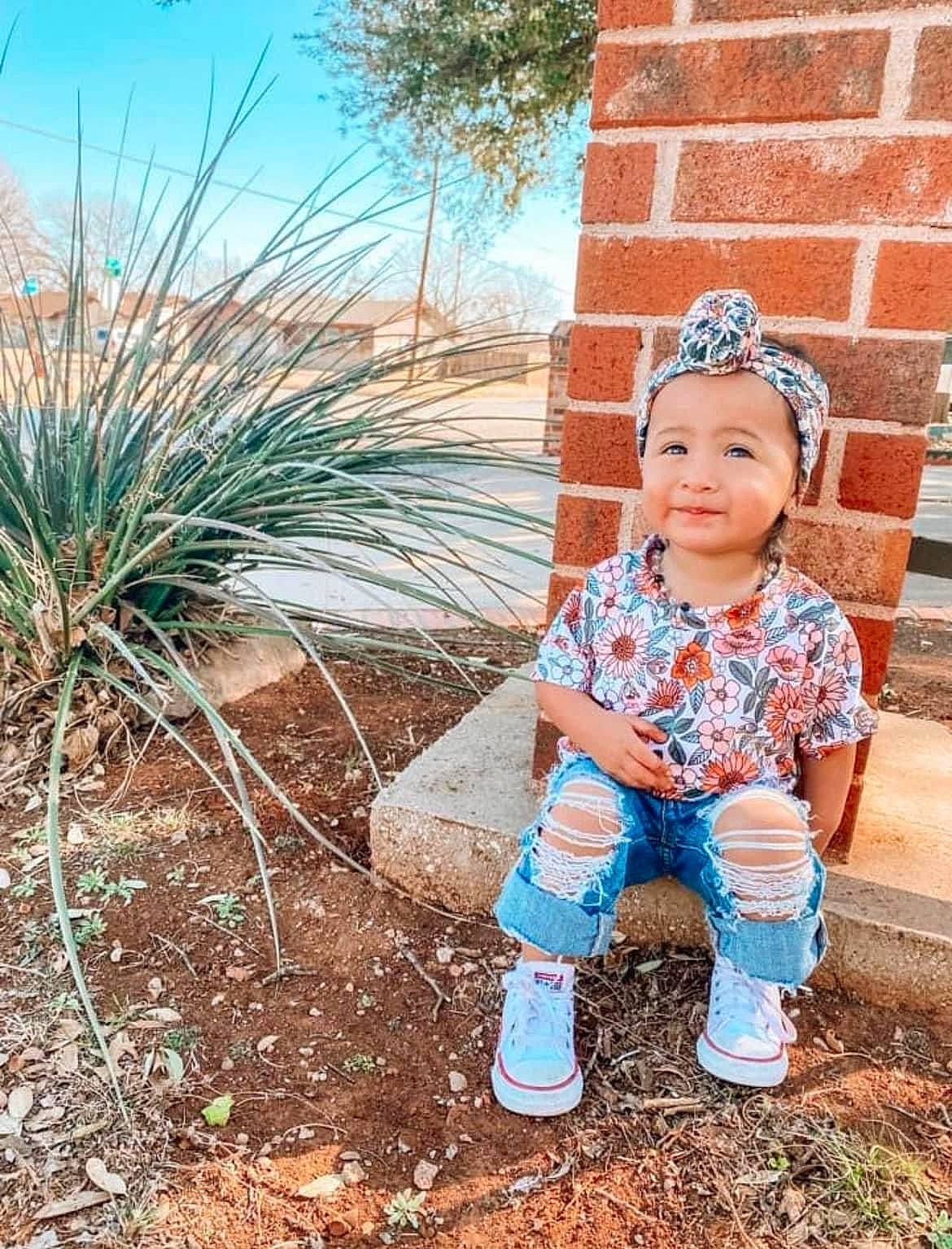 Brinley Rae is registered to the contest to win money with this photo: azure, baby, baby_toddler_clothing, brick, cap, dress, electric_blue, fun, grass, happy, hat, head, headgear, headwear, landscape, outerwear, people_in_nature, person, plant, sky