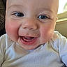 Noah is registered to the contest to win money with this photo: baby, smiling, close_up, blue_eyes, white_clothing, indoor, cheeks, teeth, face, child, infant, happy, cute, portrait, natural_light, window, skin, expression, young, person