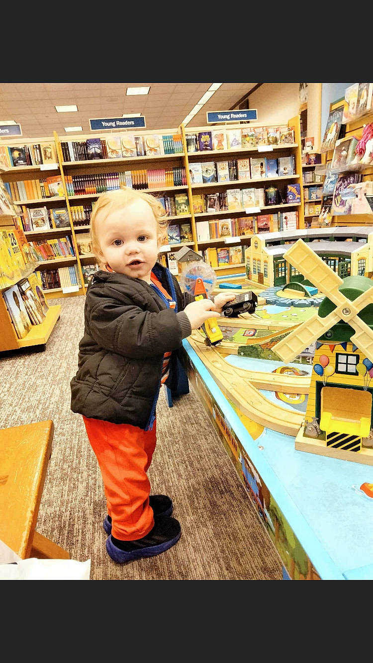 Atlas joined the competition — help win amazing prizes! baby, book, bookcase, boot, child, customer, flooring, fun, jacket, library, person, publication, retail, room, service, shelf, shelving, shopping, t_shirt, table