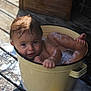 Easton is registered to the contest to win money with this photo: toddler, child, bucket, bath, soap, bubbles, water, wet, wooden_deck, outdoor, playful, curious, baby, skin, face, head, legs, feet, hands, expression