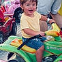 Easton joined the competition — help win amazing prizes! toddler, child, toy, motorcycle, ride, amusement_park, smiling, yellow_shirt, denim_shorts, brown_shoes, happy, outdoor, fun, play, people, colorful, green_toy, summer, cute, joyful