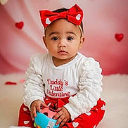 Ma'Lina joined the competition — help win amazing prizes! baby, child, valentine, red_bow, headband, toy, heart, hearts, heart_pattern, portrait, cute, sitting, indoor, soft_background, studio, clothing, red_pants, white_top, socks, expressive_eyes