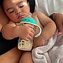 baby, infant, bottle, milk, blanket, soft, cuddle, arm, skin, face, hand, comfort, sleepy, resting, closeup, indoor, child, person, feeding, nurture