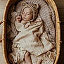 Brooks is registered to the contest to win money with this photo: baby, sleeping, blanket, basket, hat, knitted, bear_ears, cozy, infant, wooden_floor, texture, soft, wrapped, cute, resting, newborn, peaceful, indoors, portrait, warm