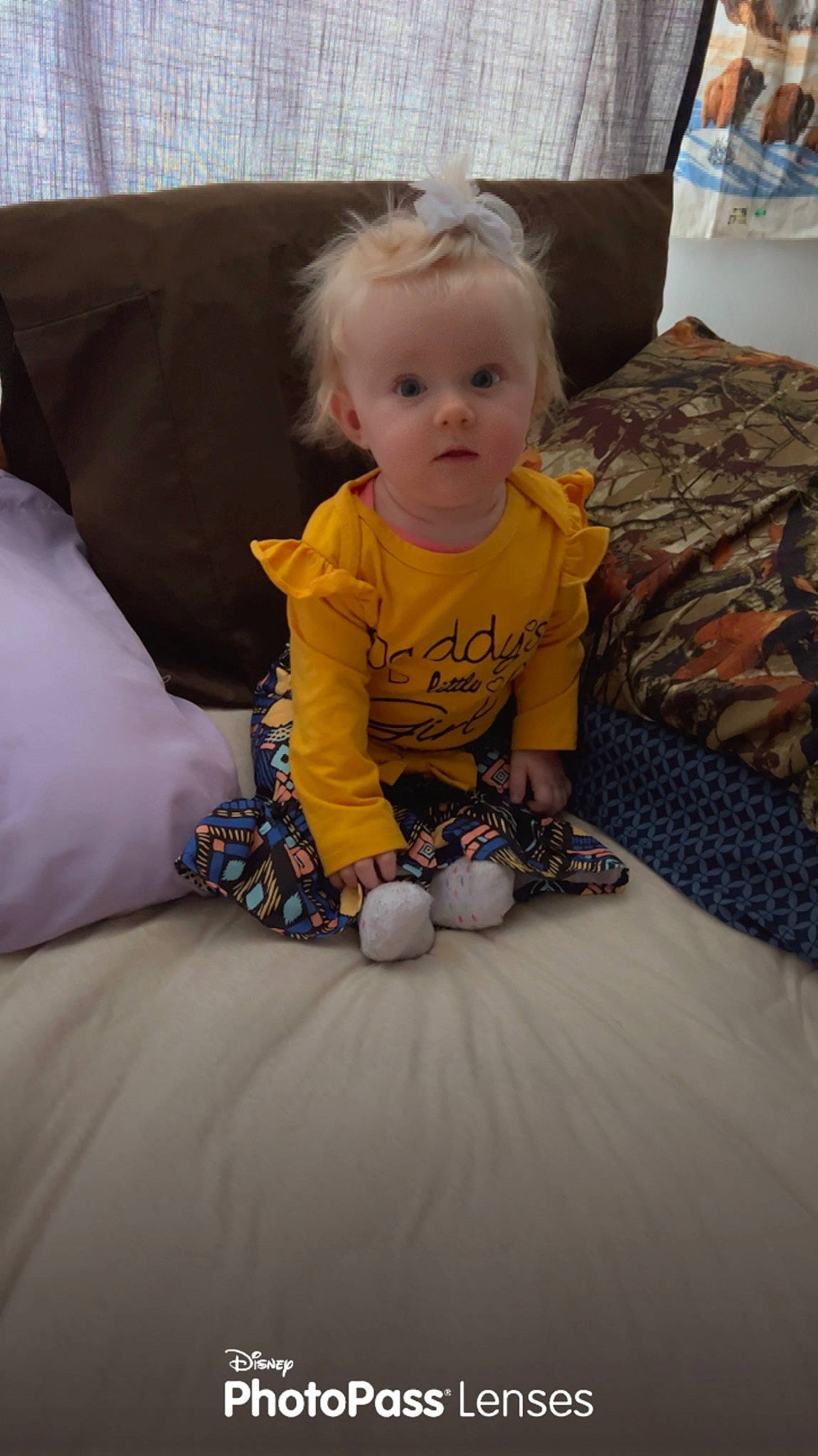 Marleigh is registered to the contest to win money with this photo: baby, baby_toddler_clothing, carpet, child, comfort, couch, crawling, face, floor, flooring, fun, hardwood, linens, living_room, person, pillow, play, room, sitting, surprise