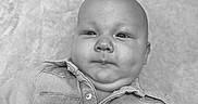 Henry joined the competition — help win amazing prizes! baby, infant, denim_jacket, black_and_white, portrait, face, child, cute, smile, lying_down, soft_texture, clothing, buttoned_jacket, closeup, chubby_cheeks, indoor, young_child, head, skin, expression