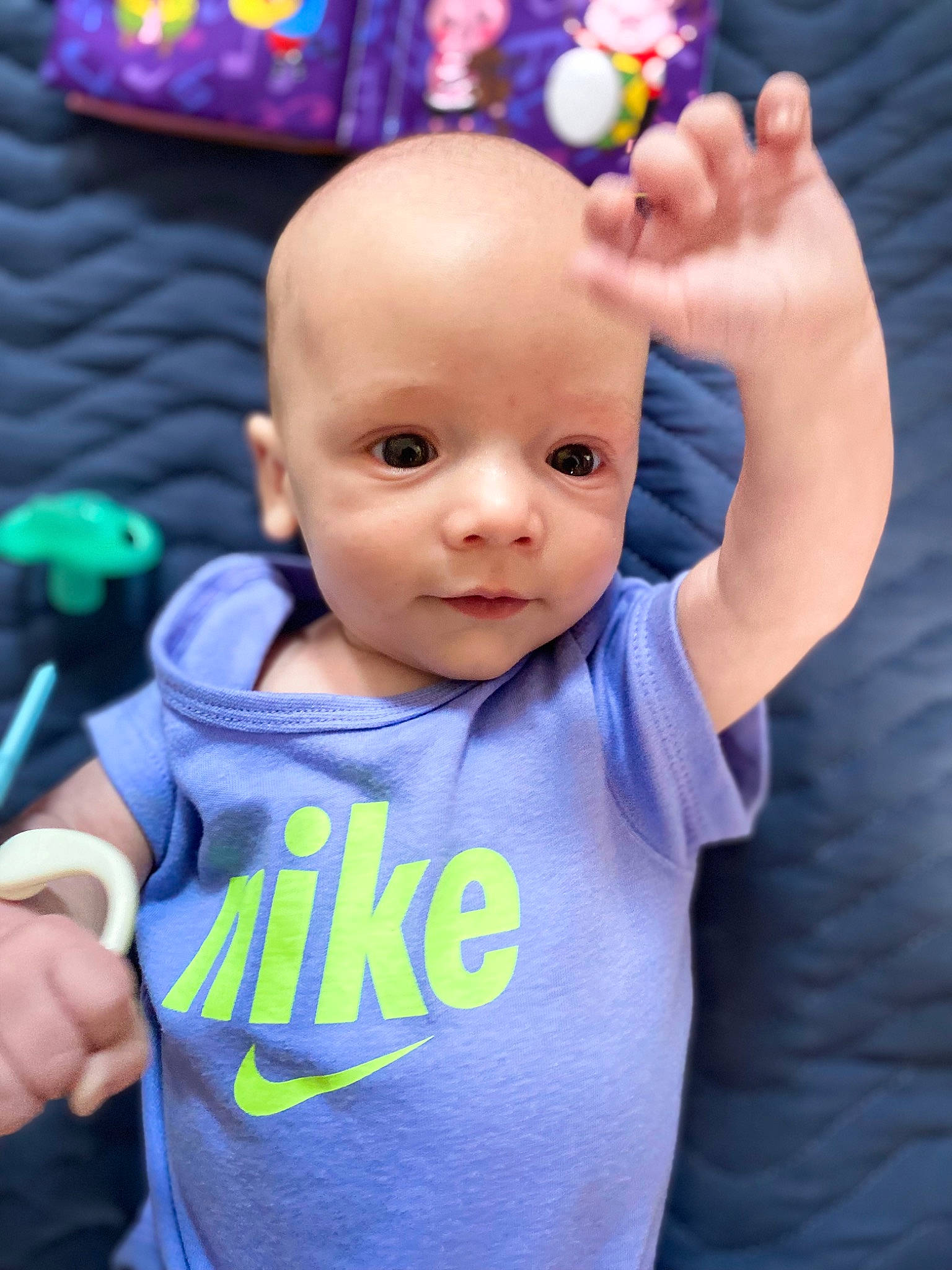 Aaron is registered to the contest to win money with this photo: azure, baby, baby_toddler_clothing, blue, cheek, facial_expression, finger, gesture, hand, happy, head, person, pink, product, purple, skin, sleeve, t_shirt, thumb, toddler