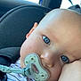 baby, pacifier, car_seat, blue_eyes, close_up, child, infant, face, skin, seatbelt, stripes, comfort, cute, young_child, indoors, resting, head, expression, soft_light, person