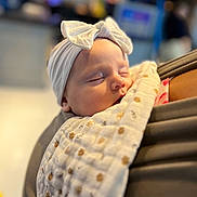Autumn Rose joined the competition — help win amazing prizes! baby, sleeping, headband, bow, blanket, patterned_blanket, infant, closeup, peaceful, soft_lighting, portrait, child, person, indoor, cozy, resting, human, cute, wrapped, toddler