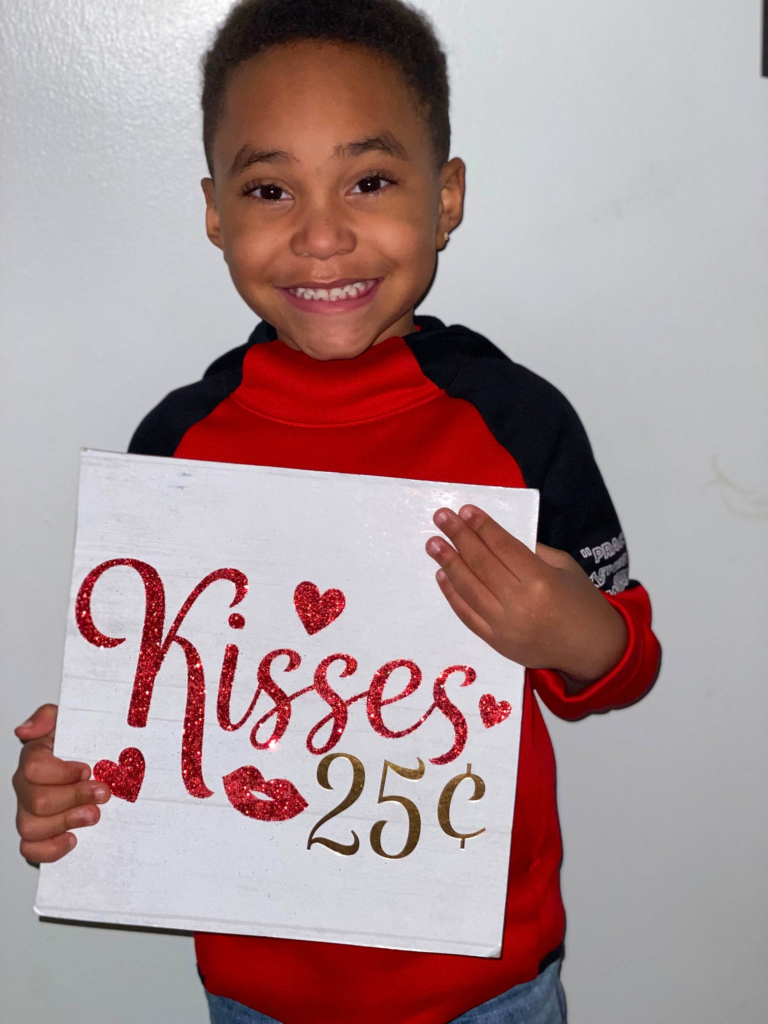 Alden joined the competition — help win amazing prizes! child, event, facial_expression, font, gesture, handwriting, happy, joy, mammal, person, product, red, room, sleeve, smile, standing, t_shirt, thumb, toddler, white