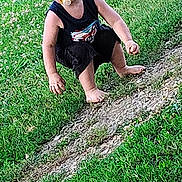 Ezra-lya joined the competition — help win amazing prizes! toddler, child, barefoot, pacifier, grass, dirt_path, outdoor, casual_clothing, black_shorts, black_tank_top, blond_hair, young_child, nature, summer, playing, crouching, curious, face, person, daylight
