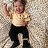 Bibianna joined the competition — help win amazing prizes! baby, smiling, tongue_out, headband, bow, leopard_print, yellow_top, black_pants, black_shoes, sitting, blanket, pattern, happy, cute, indoors, child, portrait, clothing, person, fashion