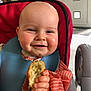 baby, child, high_chair, food, crumbs, smiling, bib, hand, face, indoor, eating, happy, chubby_cheeks, clothing, red, striped, kitchen, furniture, person, portrait