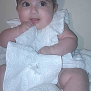 Marwa Khaliq joined the competition — help win amazing prizes! baby, infant, child, white_clothing, headband, bow, blanket, cute, indoors, portrait, closeup, chubby, skin, hand, legs, expression, sitting, fabric, soft_texture, curious