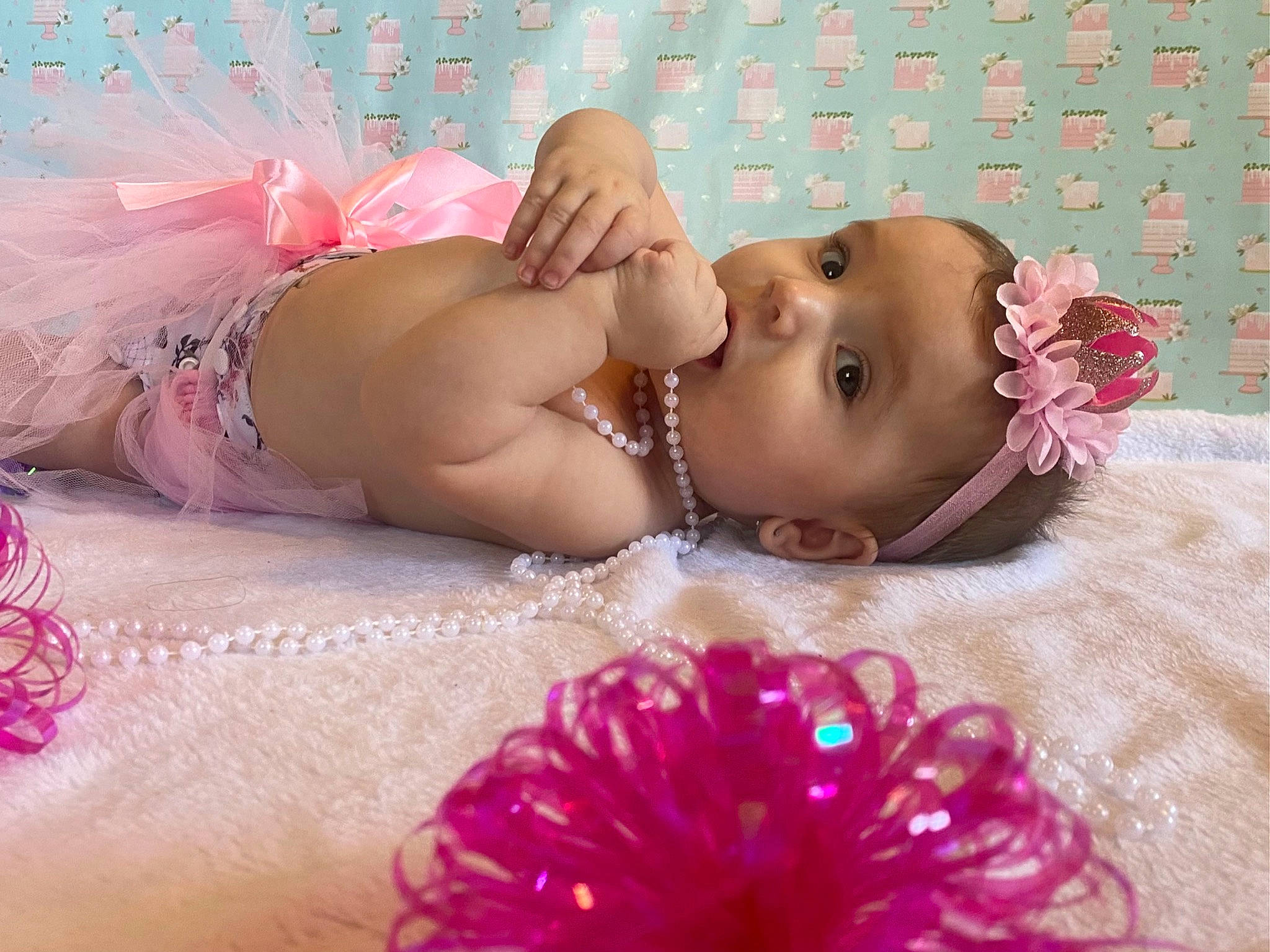 Maylee joined the competition — help win amazing prizes! baby, baby_toddler_clothing, chest, child, finger, hair_accessory, happy, head, headgear, jewellery, magenta, muscle, organ, person, petal, pink, skin, swimwear, textile, toddler
