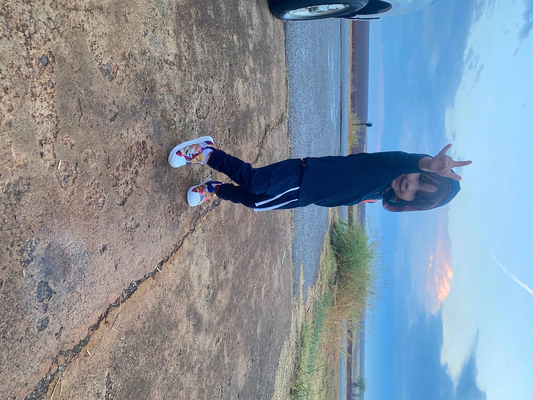 Devin joined the competition — help win amazing prizes! adventure, asphalt, composite_material, concrete, elbow, electric_blue, fun, leisure, light, person, recreation, shadow, sky, slope, soil, travel, walking_shoe, white