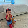 Aliya joined the competition — help win amazing prizes! toddler, child, toy, teddy_bear, pajamas, floor, tile, bed, blanket, window, indoor, cute, sitting, red, blue, hair_bow, play, young_child, person, home