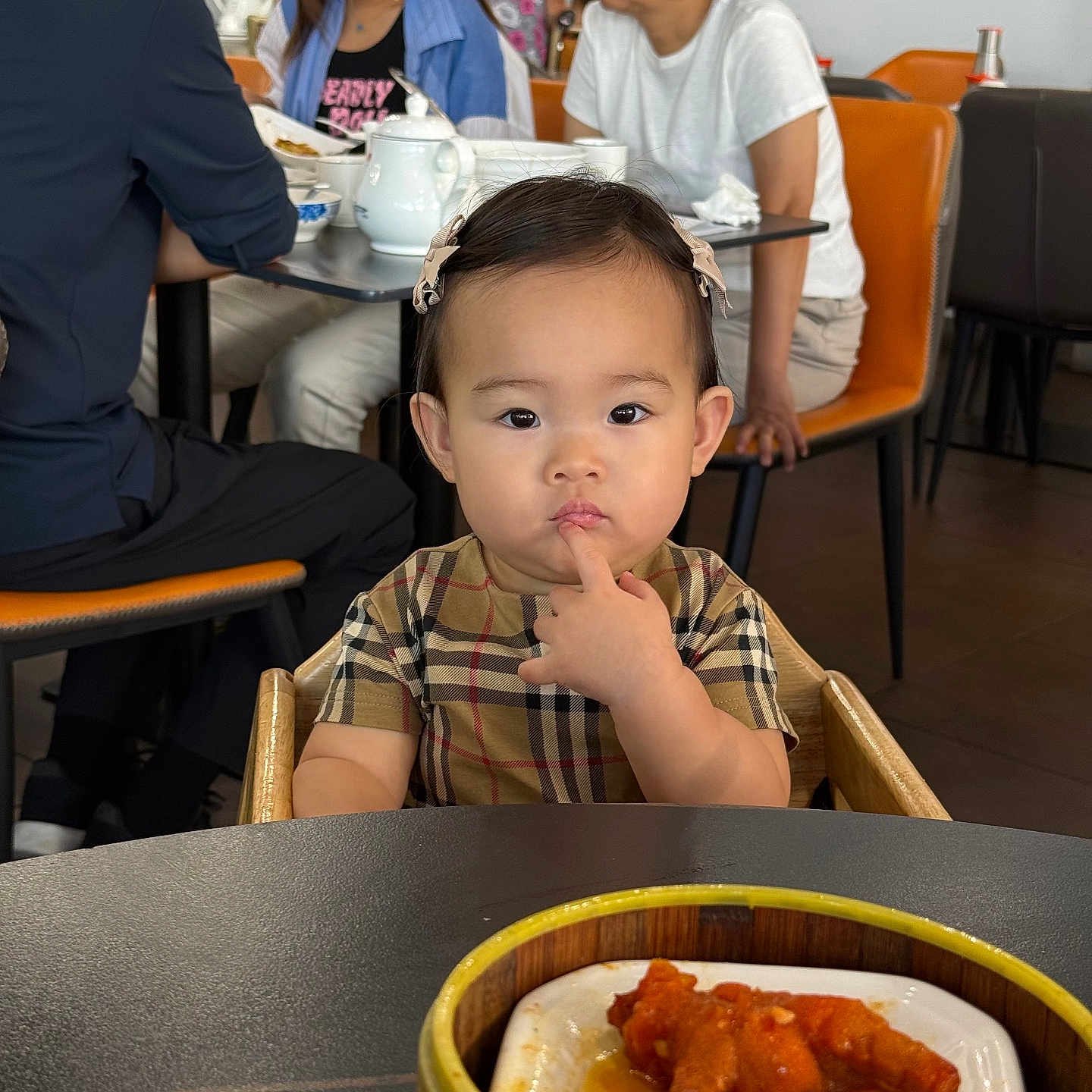 Aliya joined the competition — help win amazing prizes! adult, asian, chicken_feet, child, cup, curious, dining, food, furniture, hair_bows, high_chair, indoor, people, plaid_shirt, plate, restaurant, seated, table, teapot, toddler