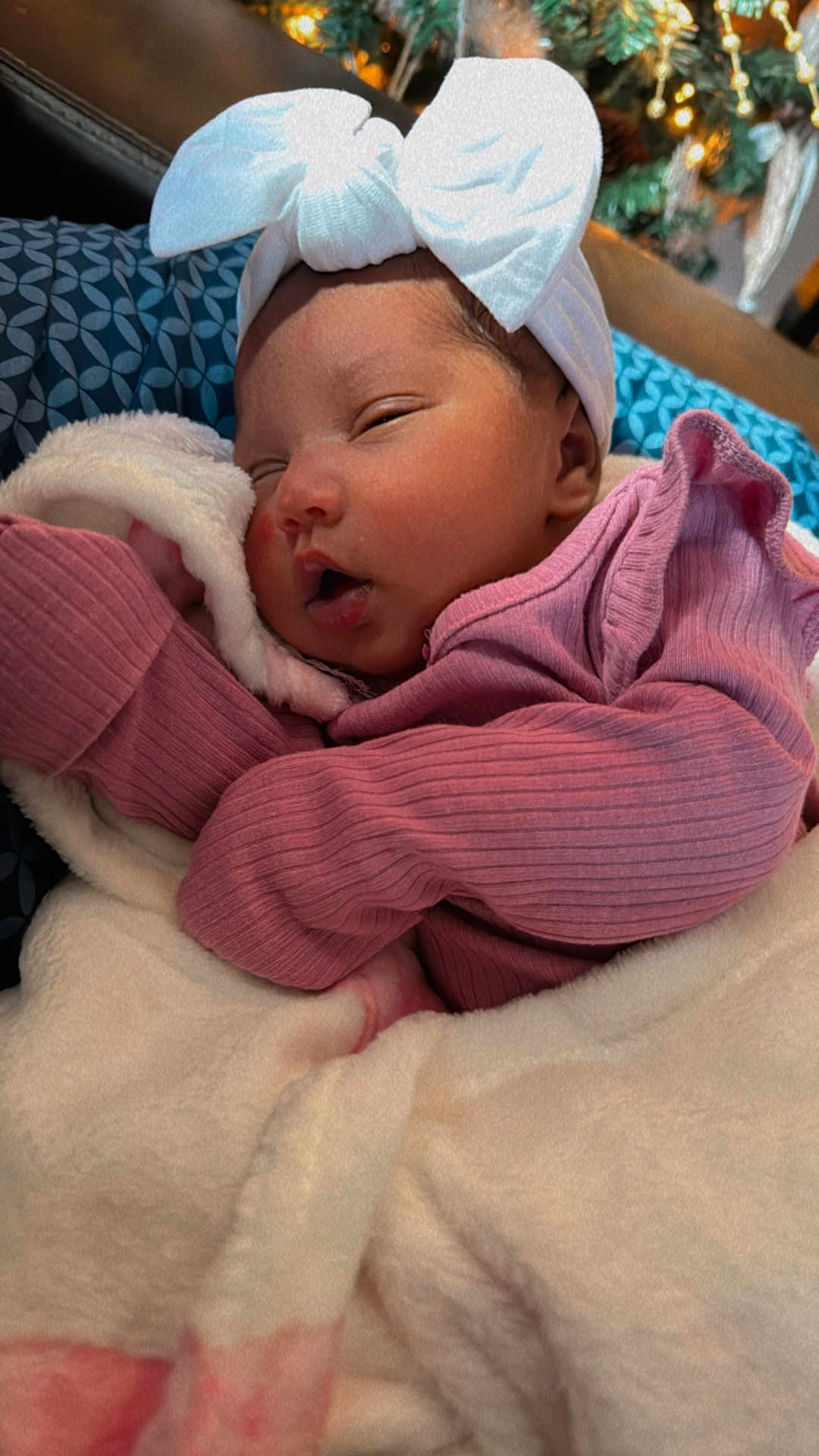 Amaïa is registered to the contest to win money with this photo: baby, sleeping, blanket, headband, pink_clothing, newborn, face, cozy, indoors, soft_texture, cute, infant, resting, portrait, warm, child, peaceful, wrapped, fuzzy, closeup