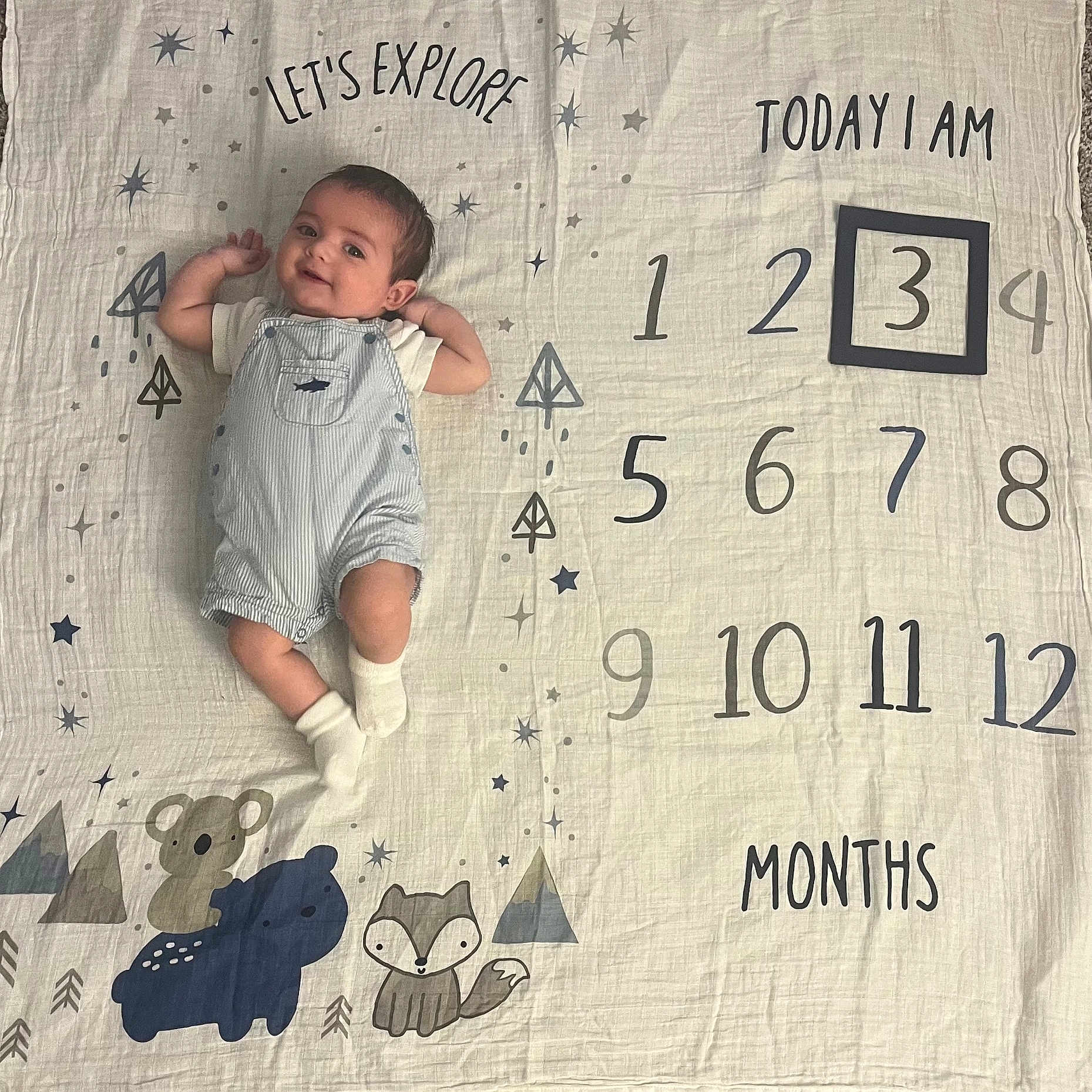 Colton is registered to the contest to win money with this photo: baby, blanket, clothing, face, furniture, head, hosiery, newborn, number, pants, person, photography, portrait, quilt, sitting, sleeping, sock, symbol, t_shirt, text