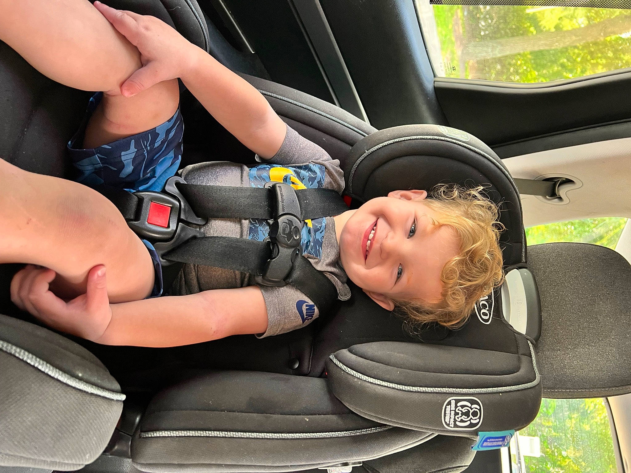Grayson is registered to the contest to win money with this photo: auto_part, automotive_design, automotive_exterior, automotive_wheel_system, car, car_seat, car_seat_cover, comfort, family_car, head_restraint, joy, luxury_vehicle, mode_of_transport, motor_vehicle, person, product, seat_belt, steering_part, steering_wheel, toddler