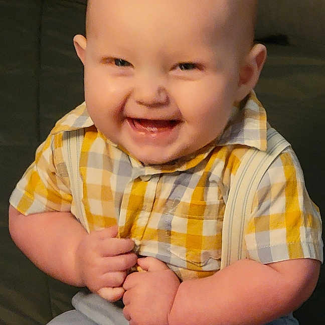 Greyson is registered to the contest to win money with this photo: baby, babylaughing, bodypart, clothing, couch, face, finger, furniture, hand, happy, head, jeans, laughing, pants, person, photography, portrait, shorts, sitting, smile