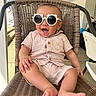 baby, child, sunglasses, chair, wicker, smiling, drool, outdoor, porch, clothing, feet, happy, infant, cute, casual, person, seat, relaxed, sunlight, fashion
