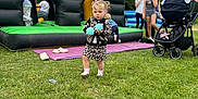 Layla-Marie joined the competition — help win amazing prizes! child, toddler, grass, outdoor, bounce_house, inflatable, ball, toy, stroller, people, children, play, leopard_print, clothing, fun, party, summer, greenery, daytime, casual