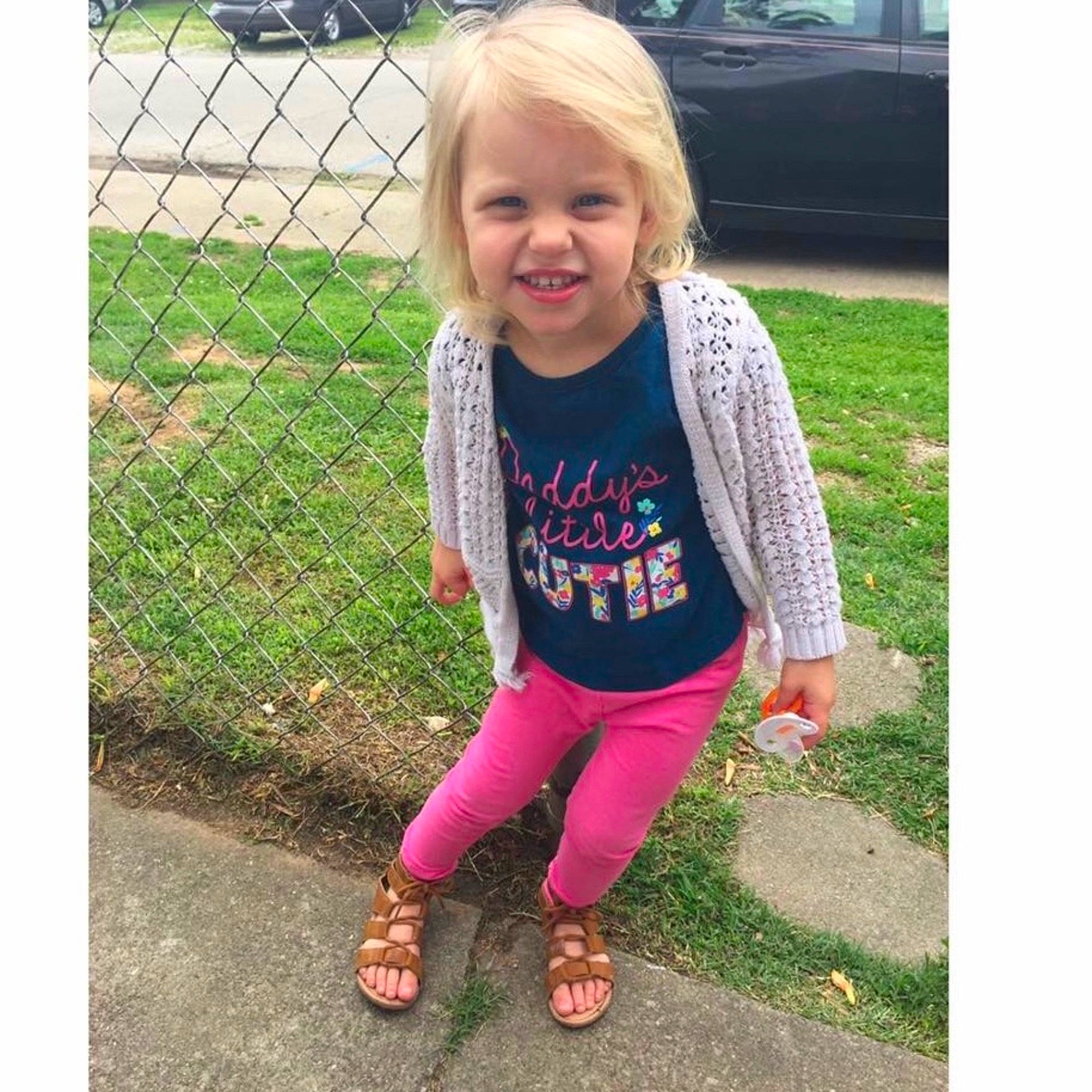 Olivia is registered to the contest to win money with this photo: child, clothing, day, footwear, girl, grass, jeans, joy, leggings, material, outerwear, pattern, person, pink, play, shoe, shorts, sweater, t_shirt, textile