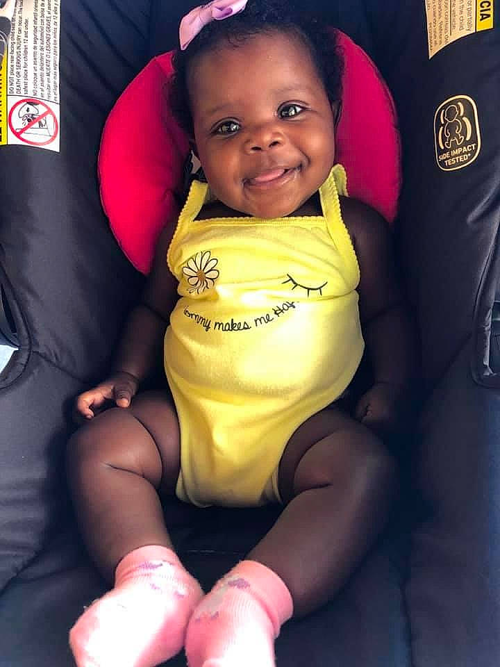 Maleah joined the competition — help win amazing prizes! baby, baby_products, car_seat, child, fun, joy, leg, person, product, sitting, smile, toddler, yellow