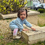 Hélyne participe au concours pour gagner de l'argent avec cette photo : child, concrete_block, crouching, curly_hair, daylight, denim_dress, girl, gravel, greenery, happy, nature, outdoor, parked_cars, pigtails, plants, playing, shoes, smiling, toddler, white_tights