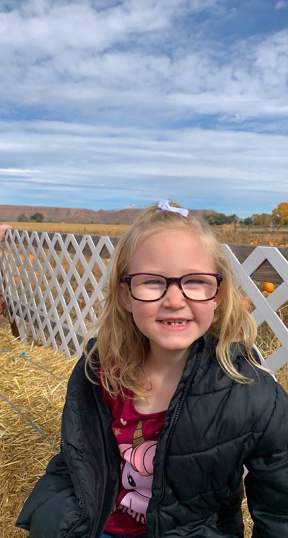 Makenna is registered to the contest to win money with this photo: blond, brown_hair, cloud, eyewear, fence, fun, glasses, grass, happy, human, iris, joy, landscape, leisure, long_hair, people_in_nature, person, sky, smile, travel