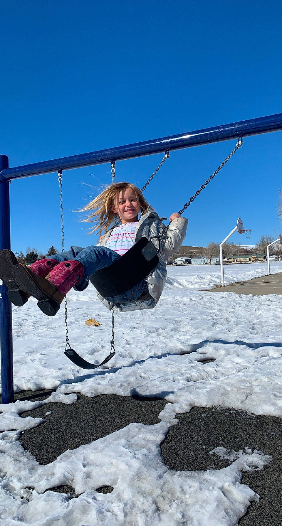 Baylee joined the competition — help win amazing prizes! adventure, city, freezing, fun, happy, joy, landscape, leisure, outdoor_play_equipment, person, playground, recreation, rope, sky, slope, smile, snow, swing, tree, vacation
