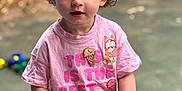 Liana-Mae joined the competition — help win amazing prizes! child, toddler, curly_hair, blue_eyes, red_soccer_ball, pink_tshirt, ice_cream_graphic, outdoor, autumn_leaves, blurred_background, standing, holding, playful, happy, cute, person, daylight, casual_clothing, young, innocent