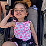 Liana-Mae joined the competition — help win amazing prizes! toddler, child, smiling, stroller, curly_hair, outdoor, sunny, plush_toy, pink_flower, clothing, seatbelt, happy, person, cute, casual, sitting, toy, daylight, skin, legs