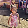 Liana-Mae joined the competition — help win amazing prizes! child, toddler, curly_hair, pink_outfit, floral_pattern, sandals, outdoor, sunlight, smiling, standing, playground, people, background, slush_stop, summer, casual_clothing, hair_buns, concrete_ground, daytime, happy