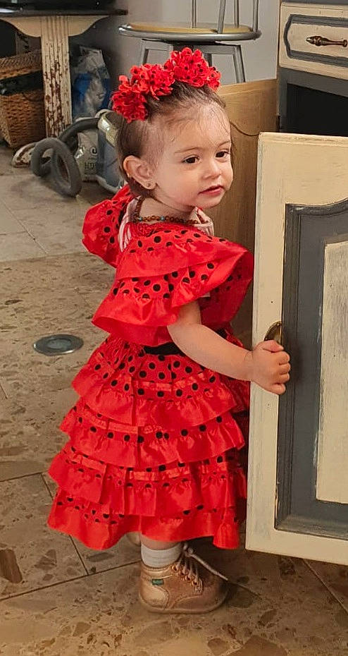 Crystal participe au concours pour gagner de l'argent avec cette photo : baby, baby_toddler_clothing, day_dress, dress, facial_expression, fashion_design, formal_wear, hairstyle, one_piece_garment, orange, pattern, people, person, photograph, pink, red, shoe, skin, sleeve, standing