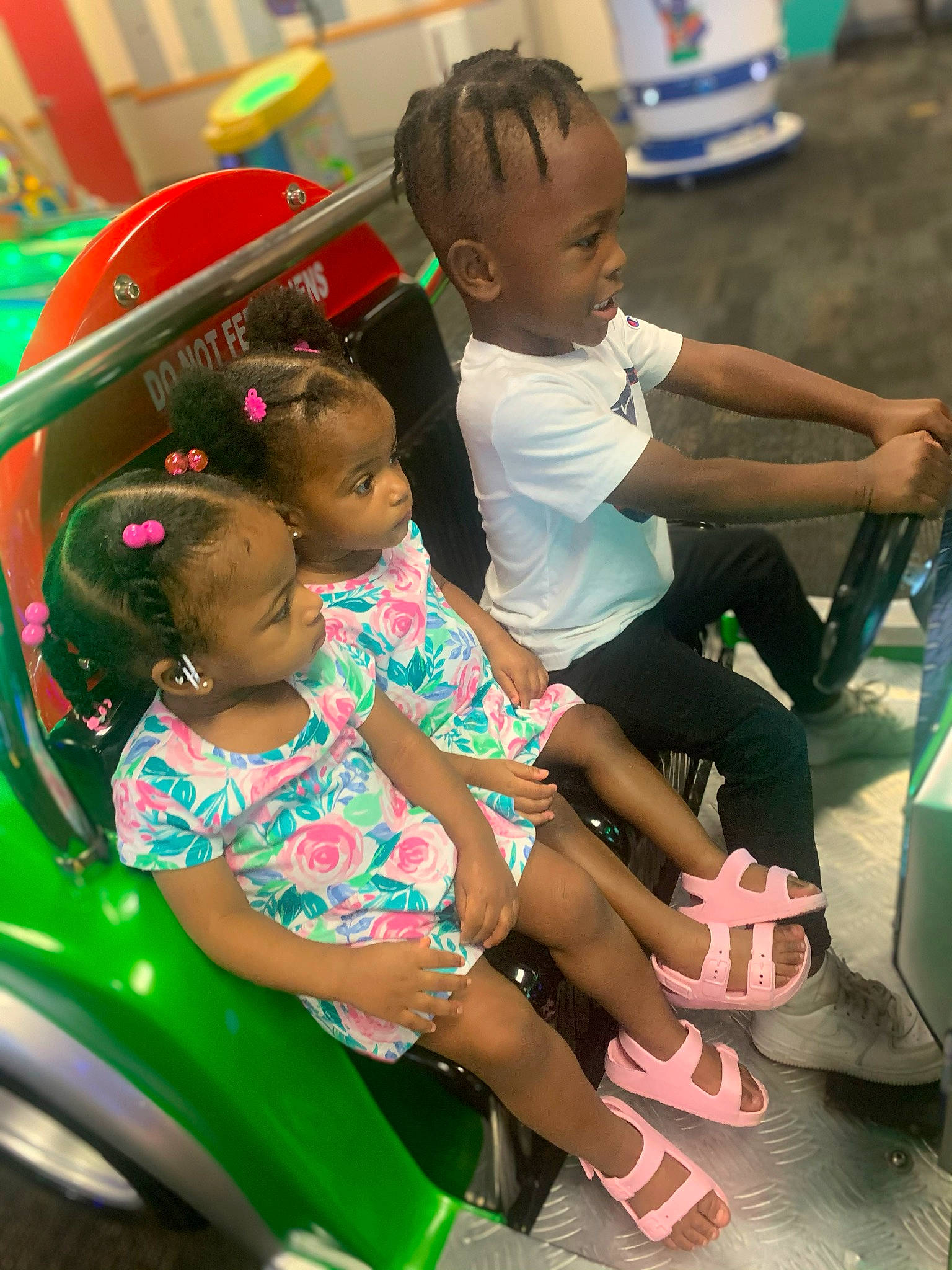 Kacy is registered to the contest to win money with this photo: chair, child, event, facial_expression, fun, green, happy, lap, leisure, motor_vehicle, person, public_space, recreation, sandal, sharing, shorts, sitting, skin, thigh, toddler