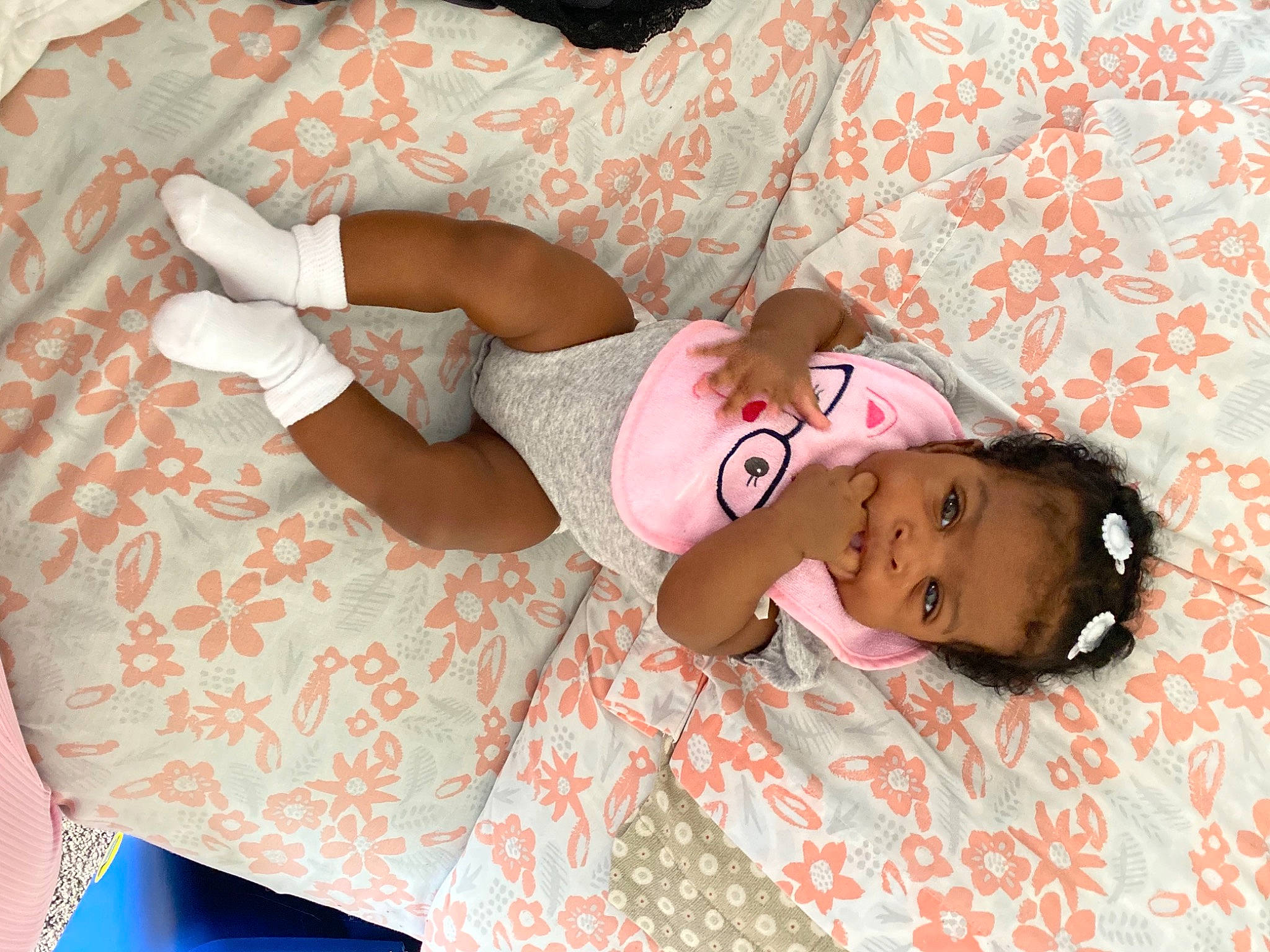 Jakhya is registered to the contest to win money with this photo: baby, baby_toddler_clothing, child, comfort, dress, glasses, hand, head, human_leg, leg, linens, magenta, mammal, pattern, person, pink, skin, sleeve, textile, thigh