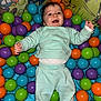 Giulian participe au concours pour gagner de l'argent avec cette photo : baby, background, ball_pit, child, colorful_balls, cute, face, fun, happy, head, indoor, infant, joy, mint_clothing, person, play_area, playtime, smiling, socks, toy