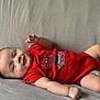 Giulian a rejoint le concours — aidez-le/la à gagner de superbes lots ! baby, infant, child, red_onesie, spiderman, smiling, lying_down, blanket, cute, hand, face, skin, young, indoors, cozy, portrait, happy, soft, comfortable, diaper