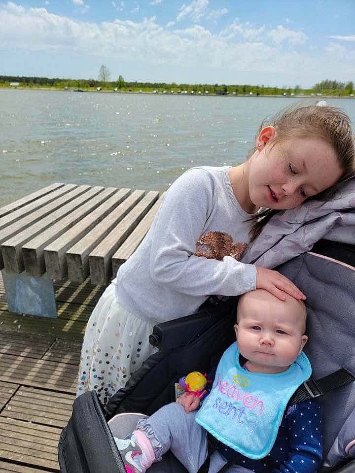 Ava Yarnevich joined the competition — help win amazing prizes! baby, baby_carriage, child, cloud, grass, green, happy, lake, lap, leisure, outdoor_furniture, people_in_nature, person, recreation, sitting, sky, smile, toddler, travel, water