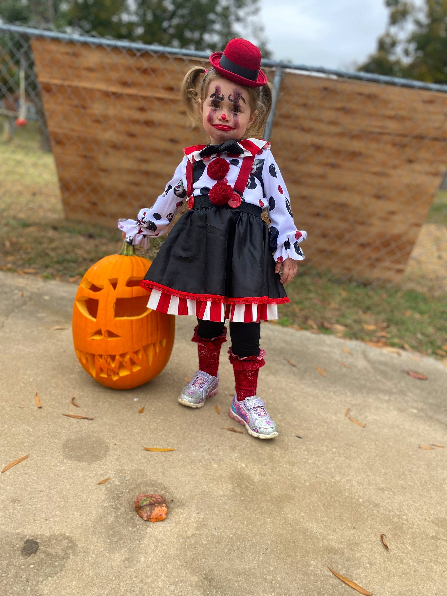 Lilah is registered to the contest to win money with this photo: calabaza, costume_hat, cucurbita, face, gourd, grass, hat, head, headgear, joy, leisure, person, plant, pumpkin, recreation, sky, squash, sun_hat, toddler, tree