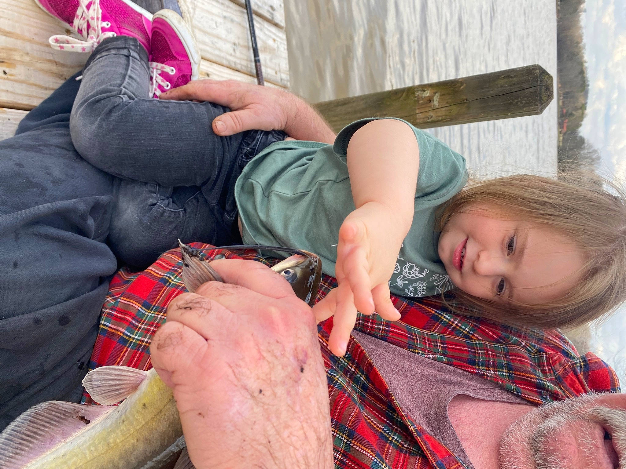 Lilah joined the competition — help win amazing prizes! child, comfort, fun, grass, hairstyle, hand, happy, human_leg, knee, lap, leg, leisure, pattern, person, plaid, sitting, tartan, textile, thigh, toddler